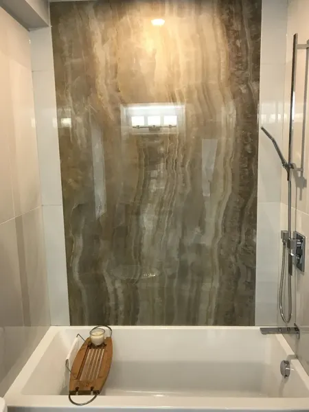 Finished bathtub wall and shower fixtures