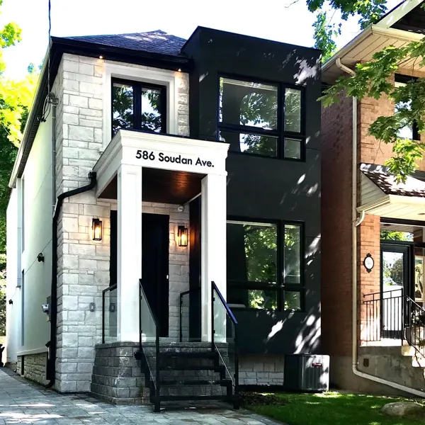 Completed front exterior — entrance and bay close view