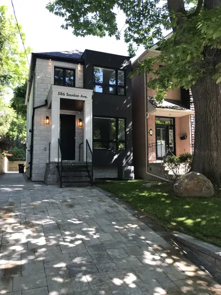 Completed front exterior — wide driveway view