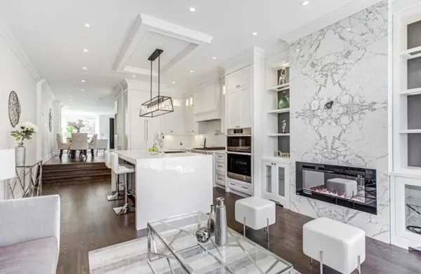Completed kitchen — fireplace wall and island toward the main floor
