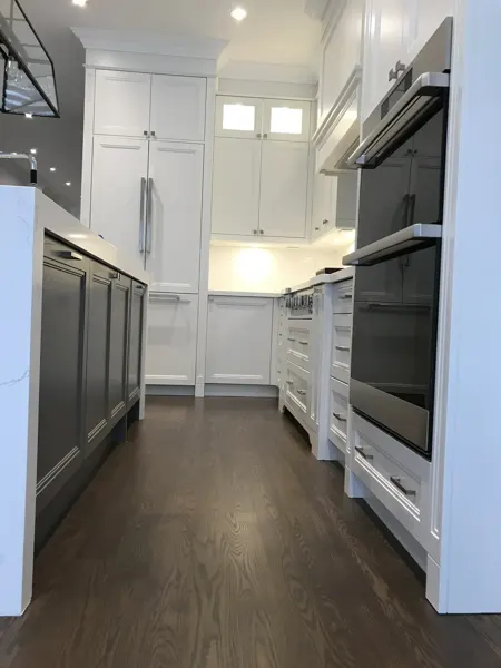Completed kitchen — cabinetry and appliance passage