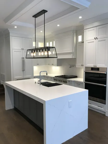 Completed kitchen — island and pendant lighting
