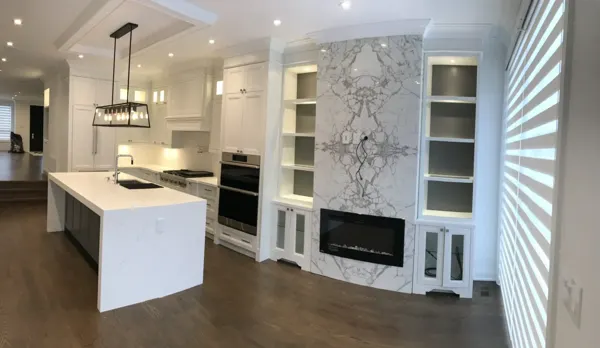 Completed kitchen — full island and fireplace wall view