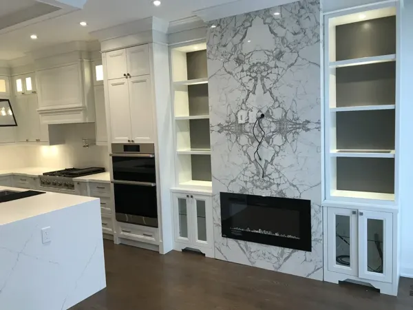 Completed kitchen fireplace — slab and illuminated shelving