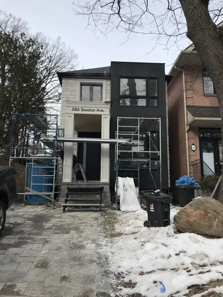Front exterior — facade finishing with scaffolding in place