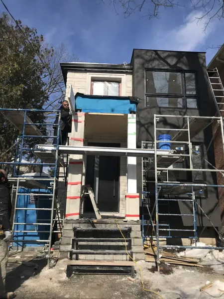 Front exterior — stone facade and canopy installation