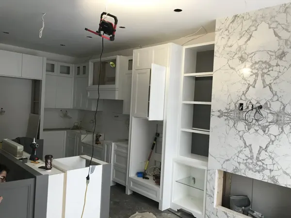 Kitchen — cabinet carcasses and fireplace surround installation