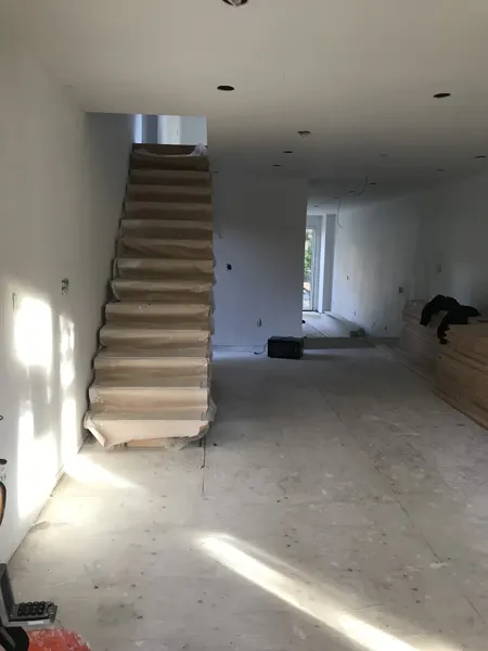 Main floor — newly boarded walls around the open staircase
