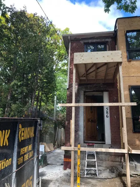 Front exterior — new entrance canopy framing