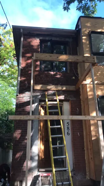 Front exterior — rebuilding around the original entrance