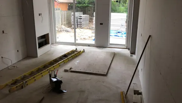 Kitchen — rear doors and unfinished floor area
