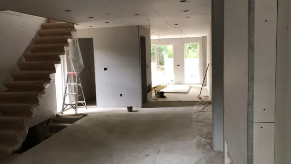 Main floor — staircase and rear opening during drywall work