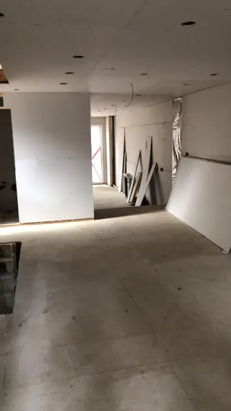 Interior — newly boarded walls and a floor transition