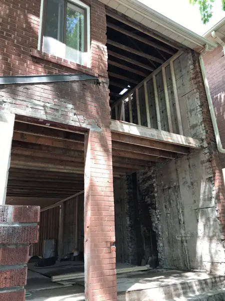 Front exterior — masonry openings exposed during demolition