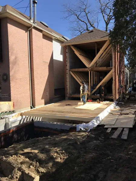Rear addition — floor framing beside the original house