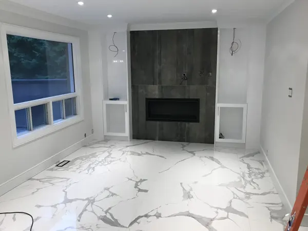Fireplace surround and cabinetry before electrical finishing
