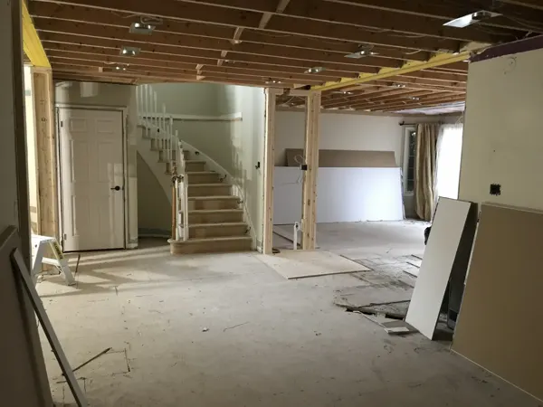 Main-floor opening work around the original curved stair