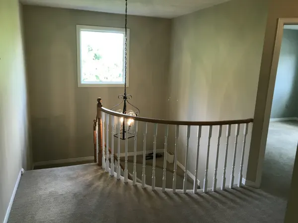 Existing carpeted upstairs landing and timber railing