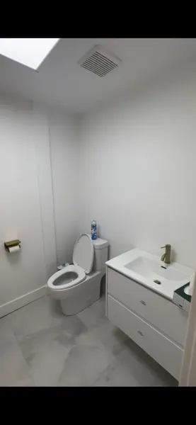 Finished washroom with new vanity, toilet and wall finish