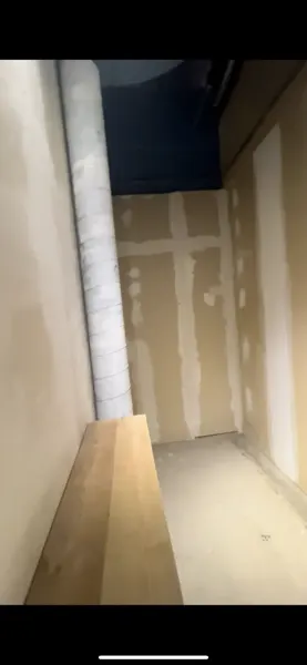 Existing treatment alcove with exposed duct and unfinished wall