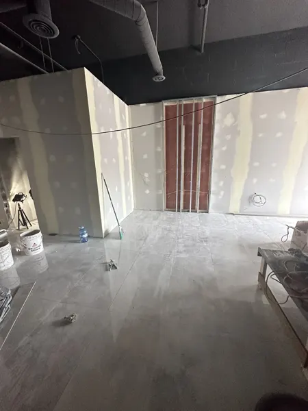 New floor tile and unfinished reception-side wall