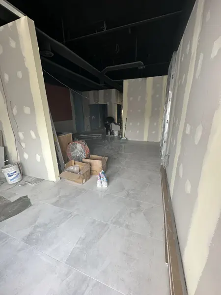 Completed tile laying while walls and fittings remain in progress