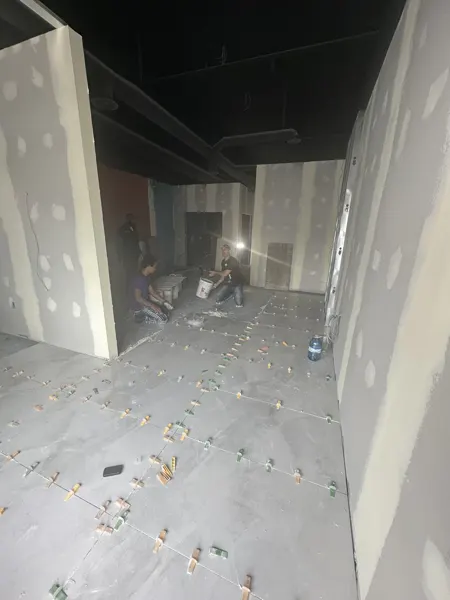 Tile setting across the salon floor