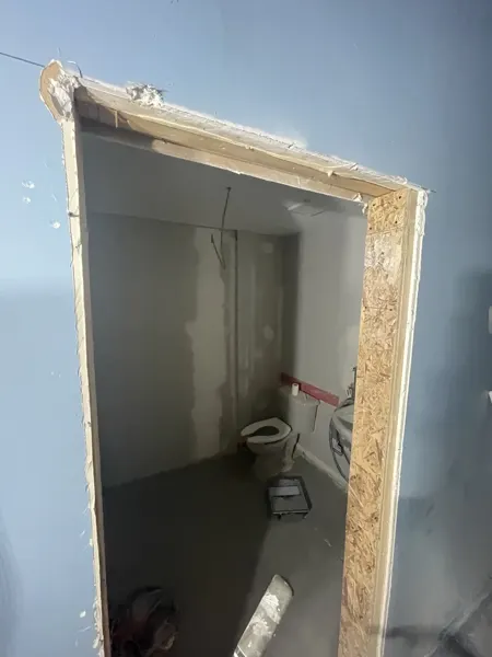 Washroom door opening and wall repairs