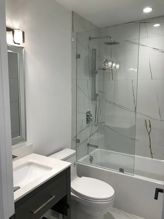 Completed bathroom — tub, shower screen and vanity