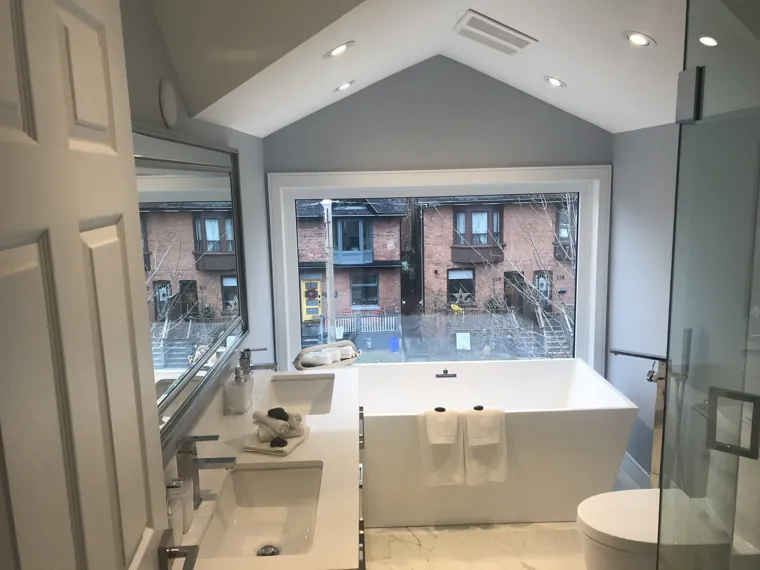 Finished bathroom beneath the sloped ceiling