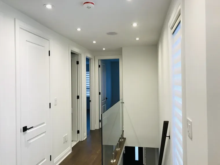 Completed upper landing — room doors and glass balustrade