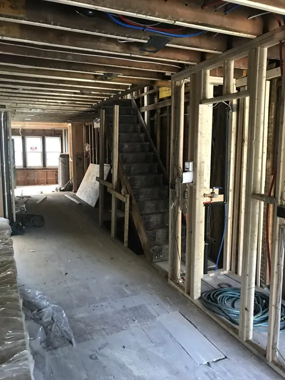 Main floor with exposed ceiling and wall framing