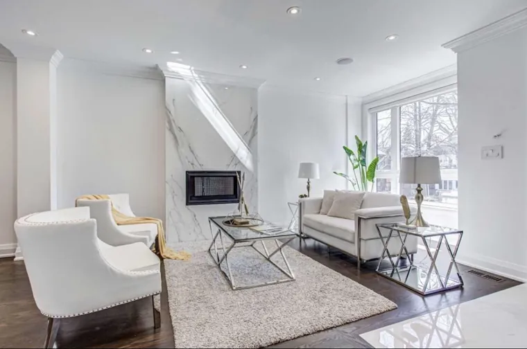 Completed living room — wide furnished fireplace view