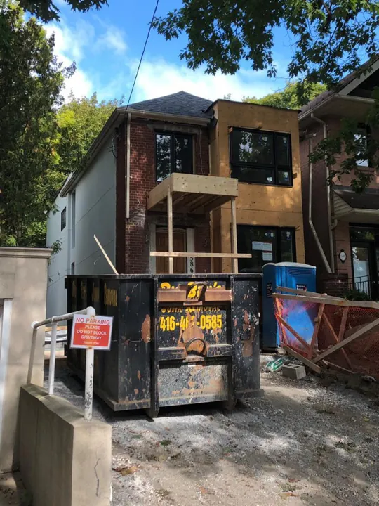 Front exterior — framed bay and entrance from the driveway